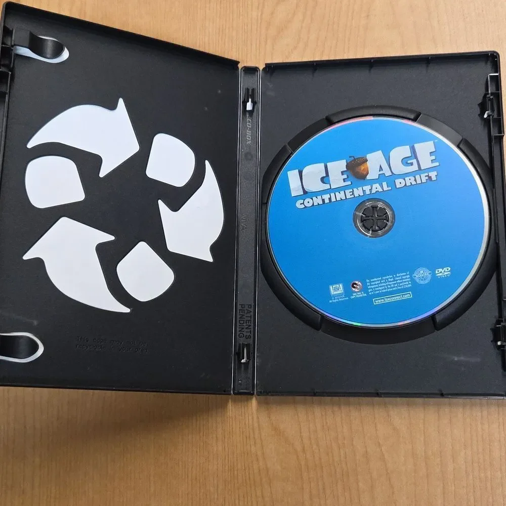 collection of Ice Age merchandise, including a VHS tape, two DVDs, Sid the Sloth